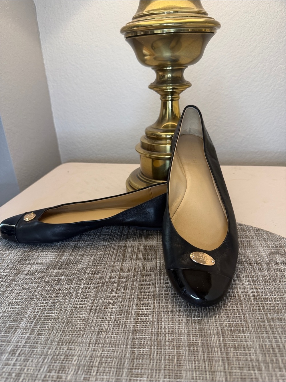 Coach Black Leather Ballet Flats with Patent Cap Toe and Gold Medallion